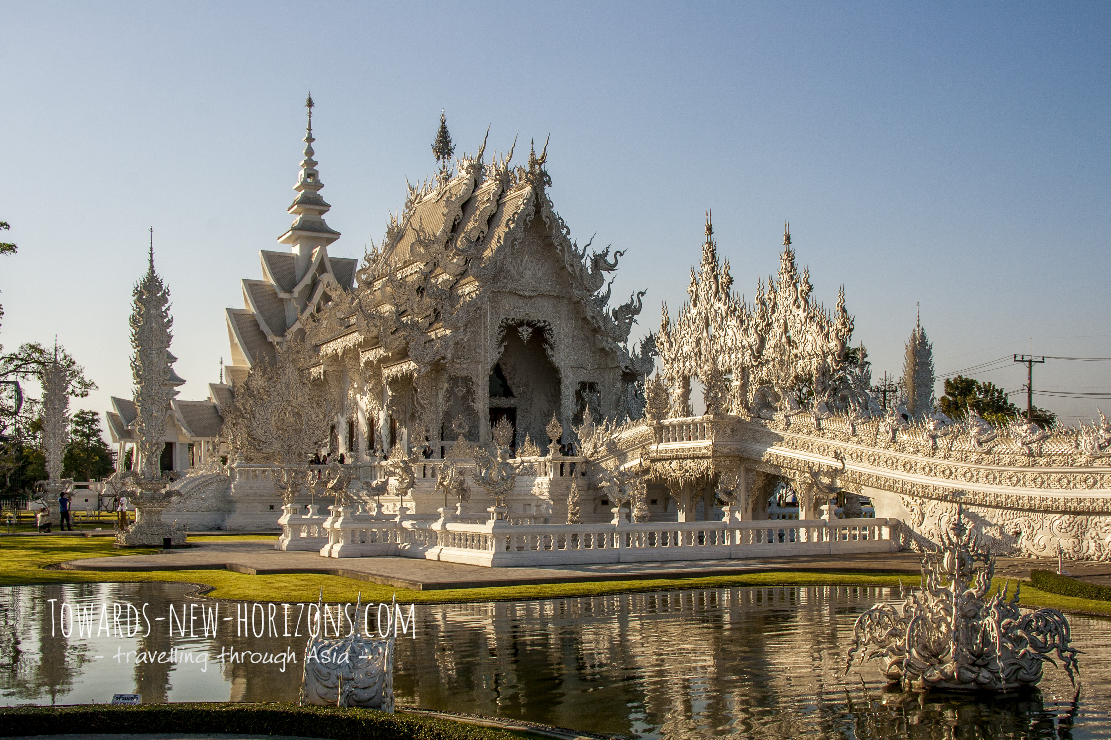 The White Temple of Chiang Rai in Thailand shimmering in the afternoon sun.